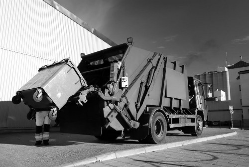 Company van and crew preparing a skip at a customer's property